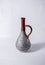 Vintage clay bottle with brown neck and silver textured painting