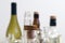 Vintage clear glass liquor bottles with cork in focus with plain