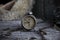 Vintage clock resting on wooden surface with military gas mask and rusty chains