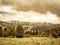 Vintage cloudy misty mountain ladscape, meadow and forest