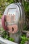 Vintage Coin public telephone in garden