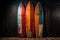 Vintage color surfboards on dark background, style 1960s California beach culture.