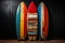 Vintage color surfboards on dark background, style 1960s California beach culture.