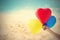 Vintage color tone balloon heart shape in hand on sea sand beach summer day and nature background