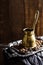 Vintage copper stovetop coffee pot shot on a dark textured wooden background