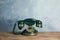 Vintage corded phone on wooden table against blue background