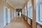 Vintage corridor inside the school building. With cast iron batteries and wooden window frames