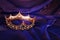 Vintage crown over dark royal purple delicate silk. fantasy medieval period