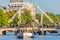 A vintage cruise boat passes the famous Amsterdam Skinny Bridge