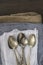 Vintage cutlery on cloths on rustic wooden background