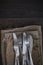 Vintage cutlery on hessian cloths on rustic wooden background