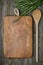 Vintage cutting board with space for text, spoon, fresh rosemary