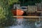 Vintage damaged orange boat with the name `Auf ein Neues