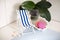 A vintage decorations striped beach chair for relaxing is standing near swimming pool or bath, seashells, soap, solid shampoo,