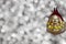 Vintage decorative christmas bauble in a shape of a crown jester against a silver bokeh blury star background