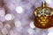 Vintage decorative christmas bauble in a shape of two kittens in a basket in golden color against a colorful bokeh background