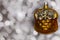 Vintage decorative christmas bauble in a shape of two kittens in a basket in golden color against a colorful bokeh background