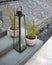 Vintage decorative glass lamp on concrete steps against waterfall background.