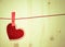 Vintage decorative red heart hanging on wood background, concept of vintage valentine day