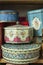 Vintage Decorative Tin Canisters on Wooden Shelf