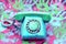 A vintage dial phone from the 80s in abstract vivid colors.