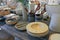 Vintage dishes and other original things on a wooden table. Plates, baskets, vases, books