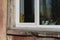 vintage doll on the windowsill among flowers