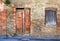Vintage door and window in brick house, Italy.