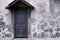 Vintage door with a wooden canopy on the background of the shabby wall, copy space