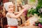 Vintage dressed child girl decorating cakes with flowers on garden tea party in spring