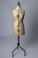 Vintage dressmakers dummy with pearl necklaces around its neck