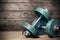 Vintage dumbbells on the wooden floor .