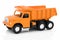 Vintage dump truck isolated on white background with shadow reflection. Plastic child toy on white backdrop.