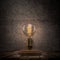 Vintage Edison light bulb on dark background.