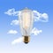 Vintage Edison Lightbulb with Glowing Filament on a Blue Sky Background with Clouds