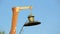 Vintage electric lamp on wooden pillar (pylon) on blue sky, vintage environment,