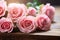 Vintage elegance Close up of gentle pink roses on rustic board