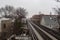 Vintage elevated subway tracks cutting through urban neighborhood