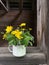 Vintage enamel mug with small bouquet of buttercups