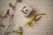 Vintage engagement ring of red gold in a gray jewelry box on the background of calligraphy and flowering