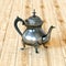 Vintage English style coffee pot on hardwood table . 3D render