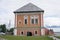 Vintage facade of a brick dand wooden two-storey house in traditional Russian style. Front view colse up.