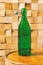 Vintage faceted green bottle of wine on a wooden winery table in the shop
