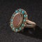 Vintage, fancy ring with precious, colorful stone isolated on a black background