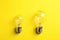 Vintage filament lamp bulbs on yellow background