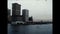 A vintage film shot looking back from a boat toward the New York City skyline from the 1970s