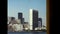 A vintage film shot looking back from a boat toward the New York City skyline from the 1970s