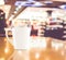 Vintage filter : White coffee cup on wood table at blur cafe background with bokeh light