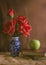 Vintage filtered rose in vase with apple and books.