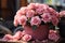 Vintage filtered still life pink rose bouquet in pot on table